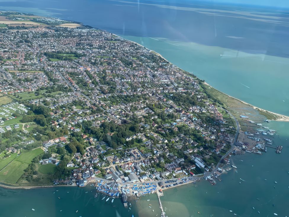 An aerial view of a coastal area with houses and boats at Island Retreat in Colchester