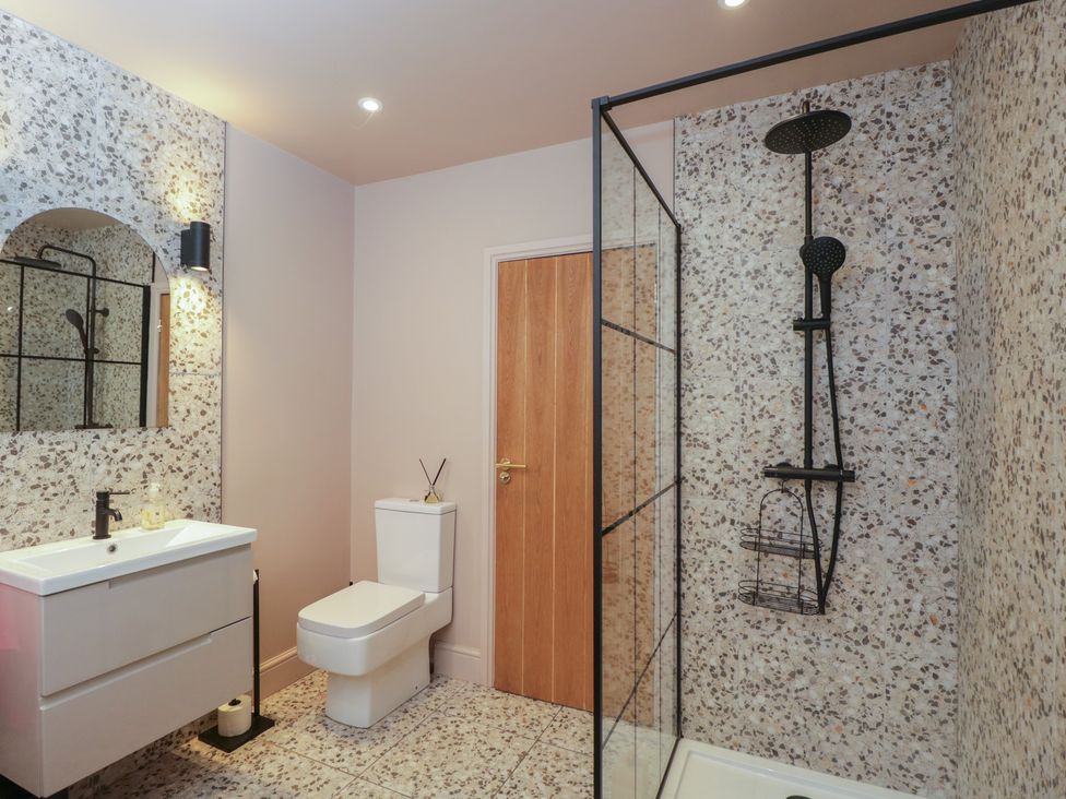 A bathroom with a shower and sink at Copper Cottage in Devizes