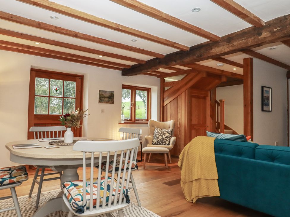 A dining room with a table and chairs at Pylemoor Cottage Washfield near Tiverton