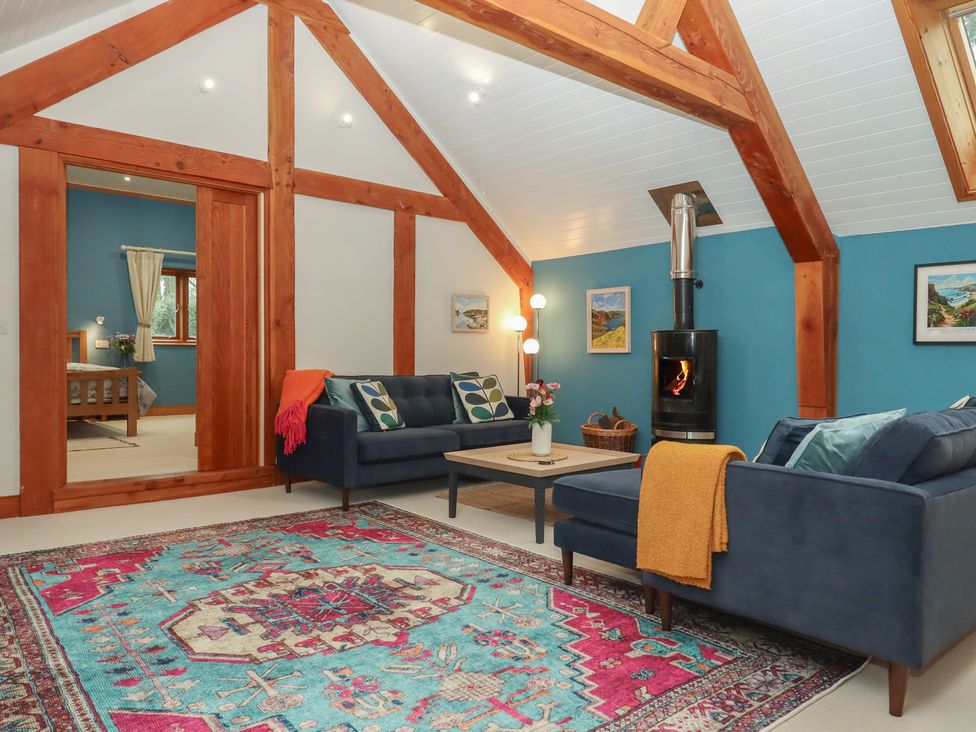 A living room with sofas and a coffee table at Pylemoor Cottage in Washfield near Tiverton