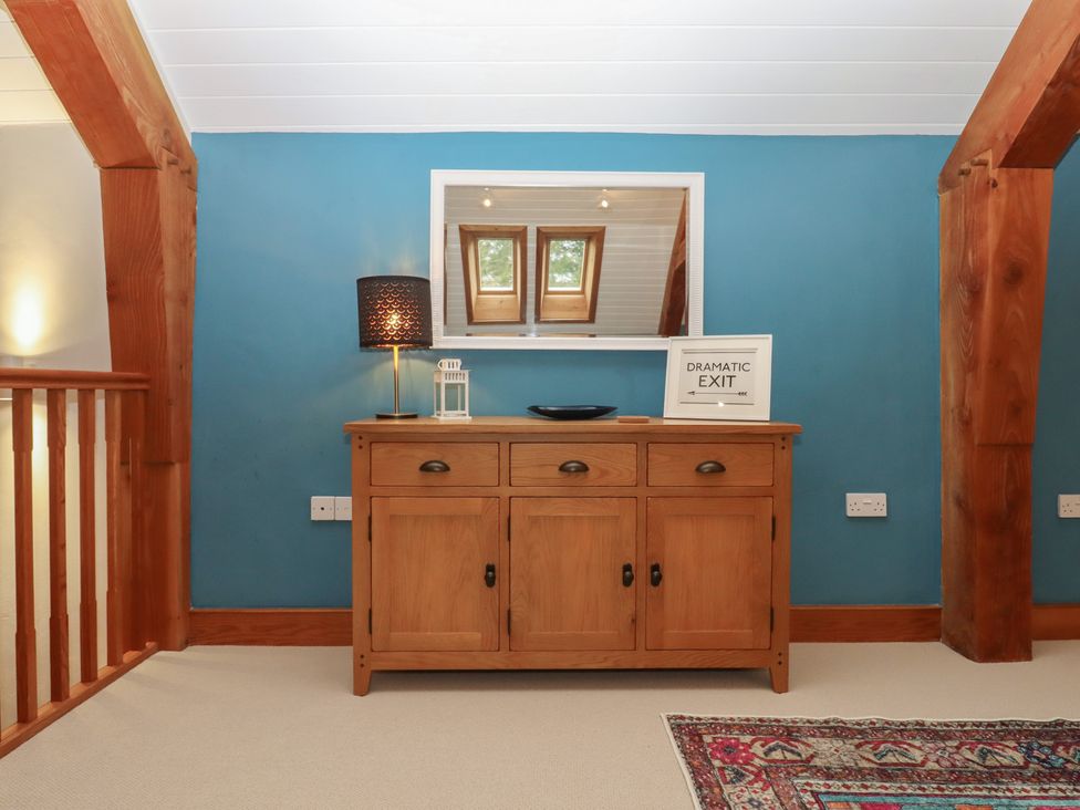 A landing area with a sideboard and lamp at Pylemoor Cottage in Washfield near Tiverton