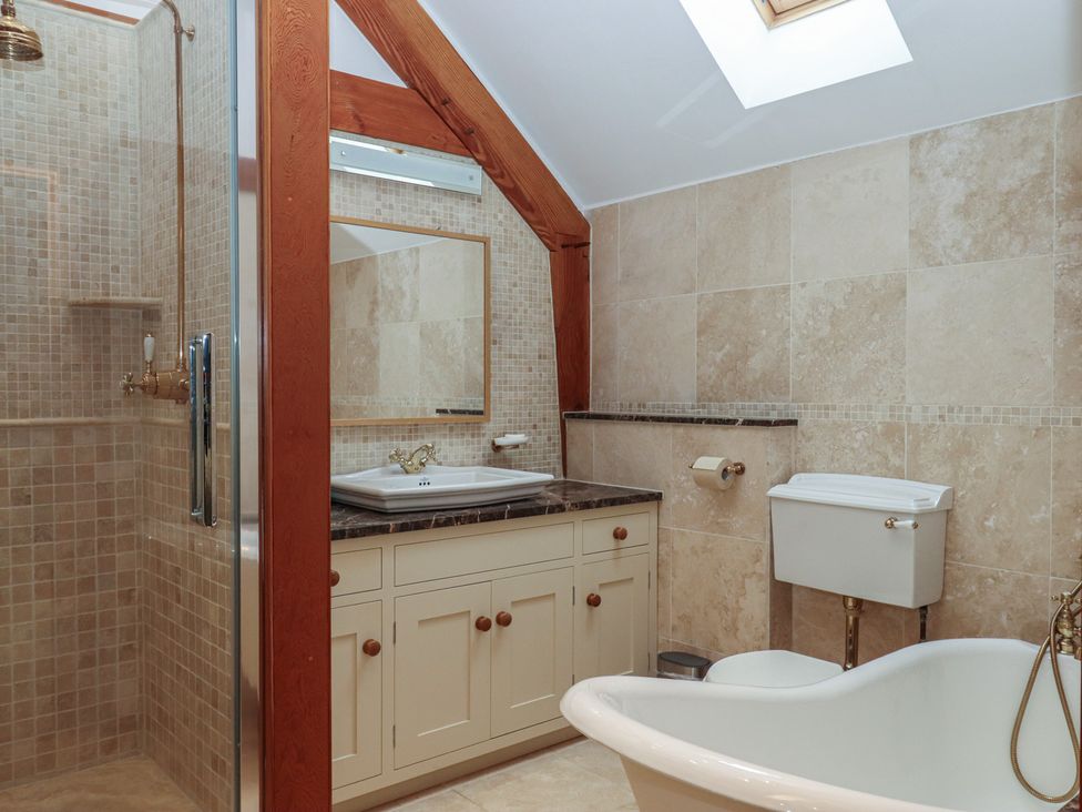 A bathroom with a shower, bathtub, sink, and toilet at Pylemoor Cottage in Washfield near Tiverton
