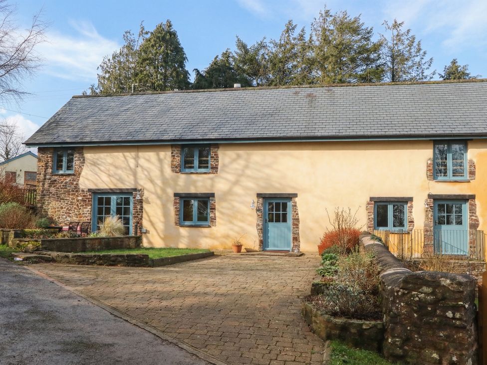 A house with a garden and pathway at Pylemoor Cottage in Washfield near Tiverton