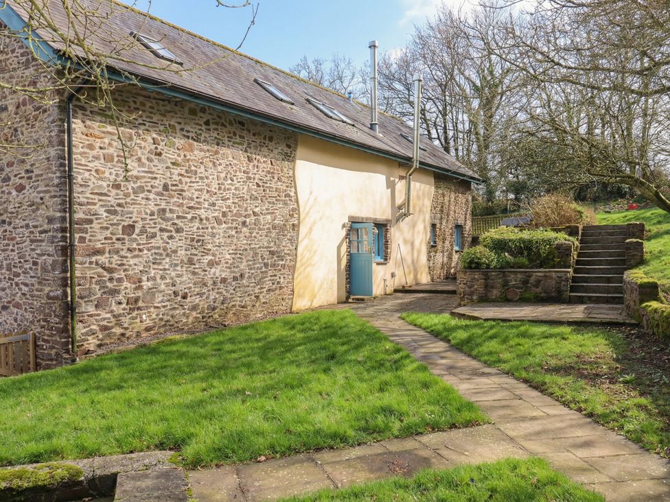 A garden with a pathway and steps at Pylemoor Cottage in Washfield near Tiverton