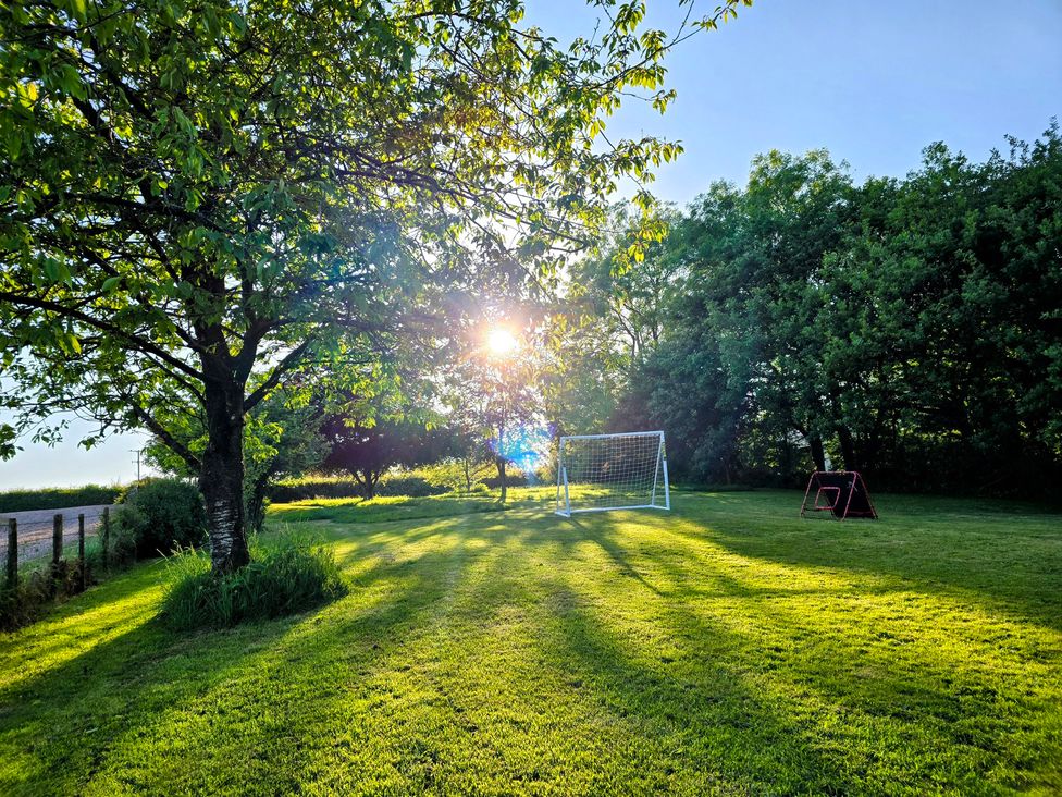 An outdoor area with a goalpost and trees at Pylemoor Cottage in Washfield near Tiverton