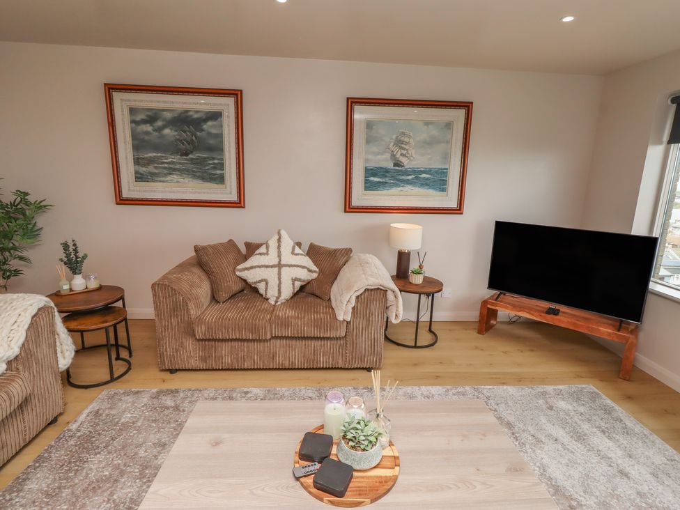 A living room with a sofa and TV at Tigh-Na-Mara Retreat