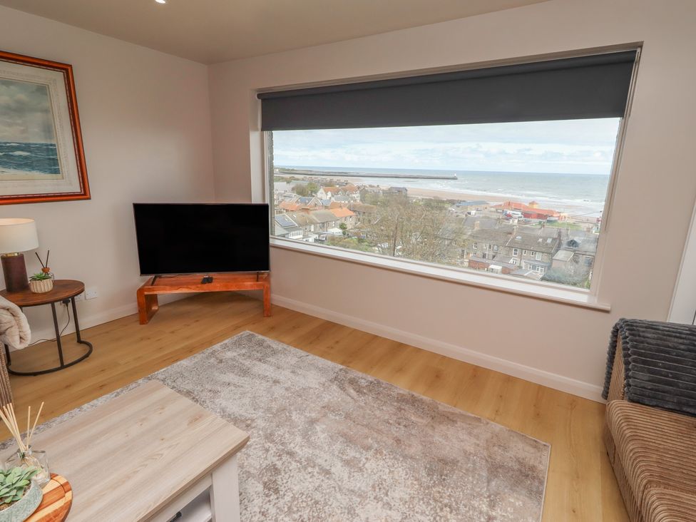 A living room with a large window offering a view at Tigh-Na-Mara Retreat