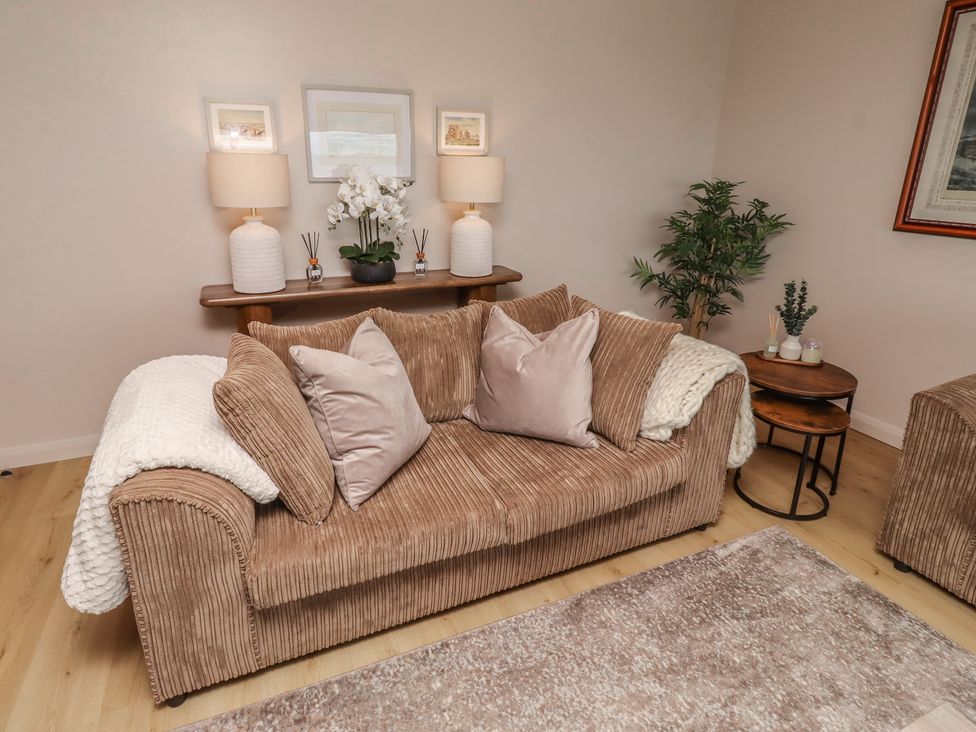 A living room with a sofa and decorative items at Tigh-Na-Mara Retreat