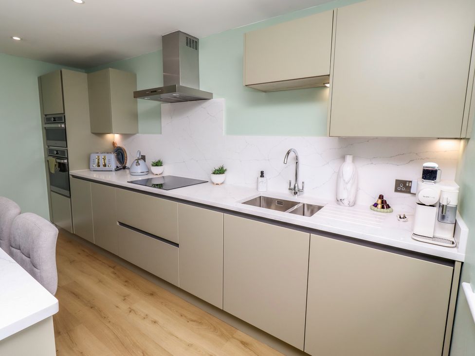 A kitchen with cabinets and appliances at Tigh-Na-Mara Retreat 