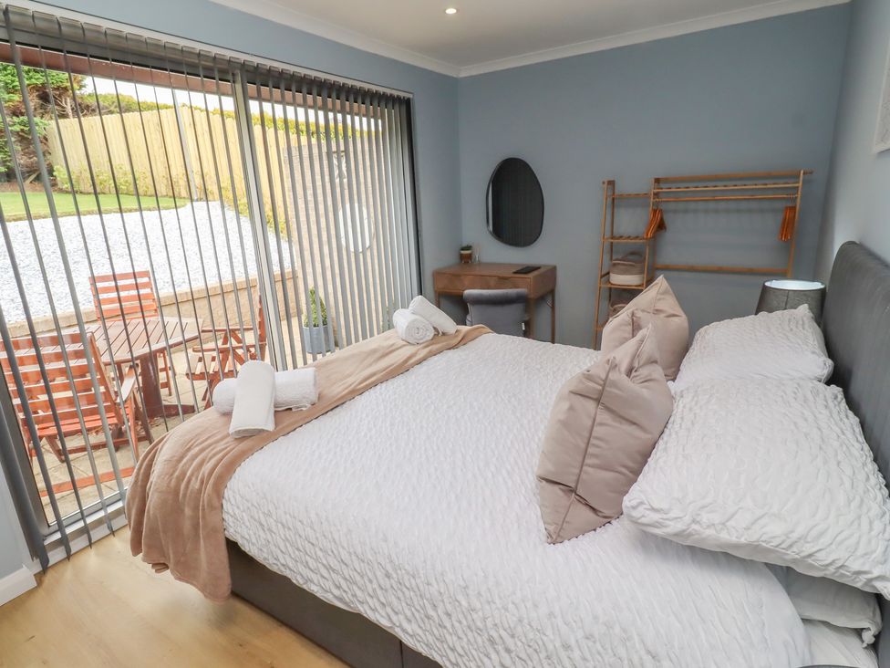 A bedroom with a bed and bedside table at Tigh-Na-Mara Retreat