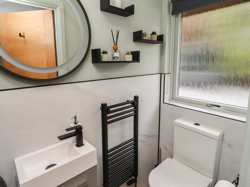 A bathroom with a sink, toilet, and a towel rail at Tigh-Na-Mara Retreat
