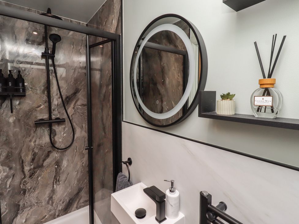 A bathroom with shower and sink at Tigh-Na-Mara Retreat