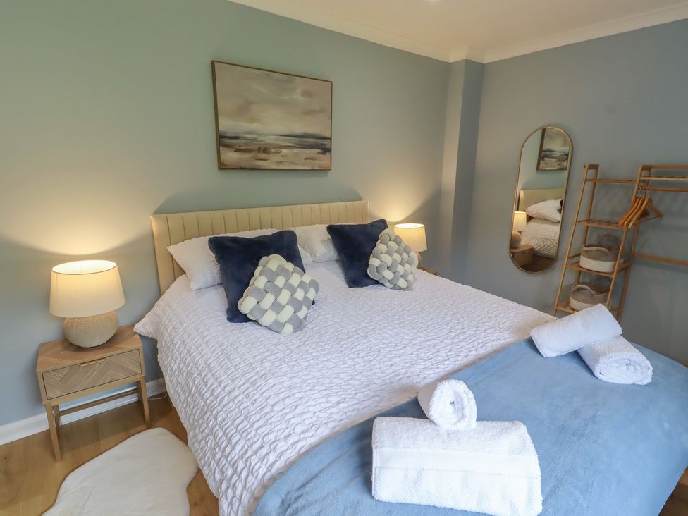 A bedroom with a bed and bedside table at Tigh-Na-Mara Retreat