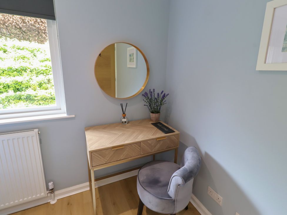 An office with a desk, chair and mirror at Tigh-Na-Mara Retreat