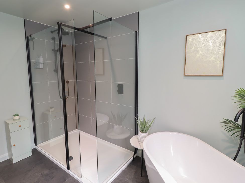 A bathroom with a shower and bathtub at Tigh-Na-Mara Retreat