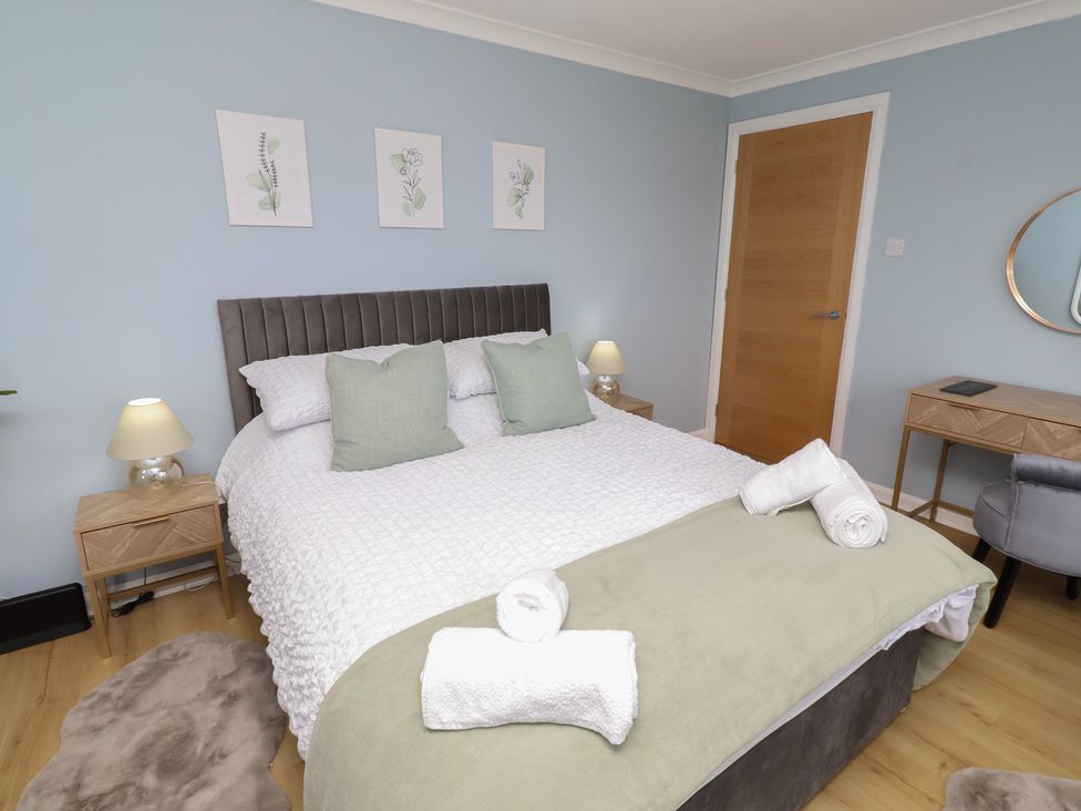 A bedroom with a bed and bedside table at Tigh-Na-Mara Retreat