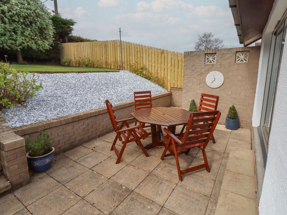 A patio with a table and chairs at Tigh-Na-Mara Retreat