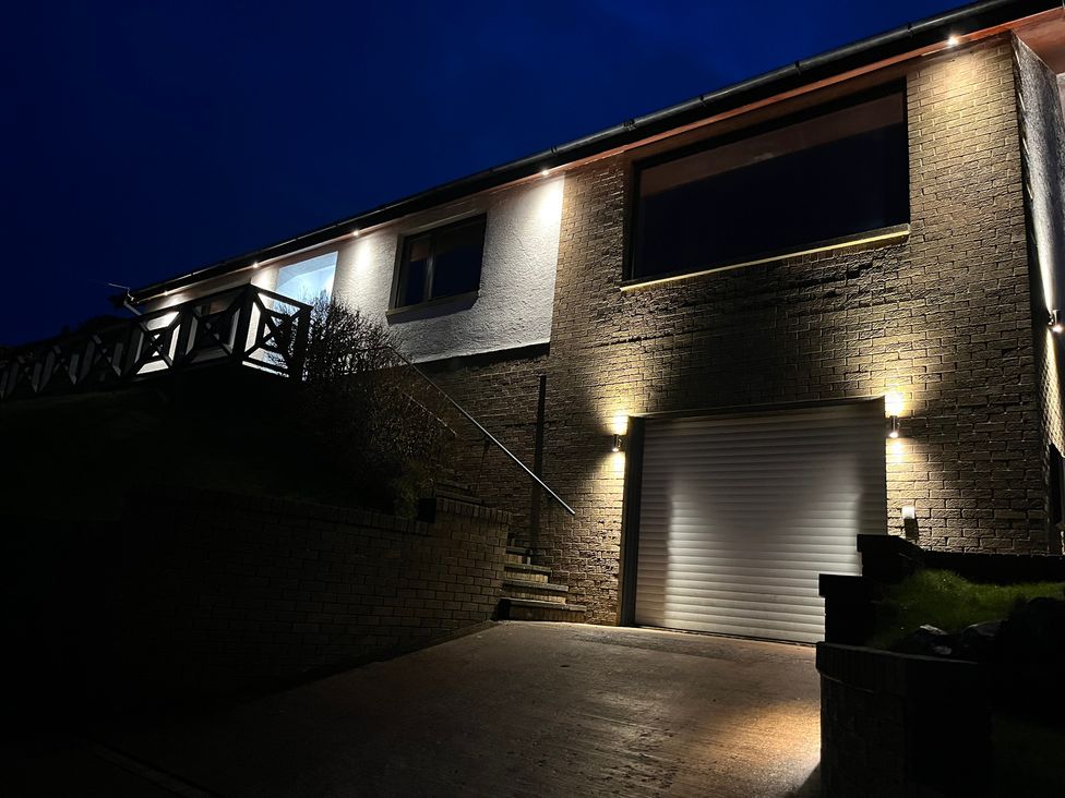 A house exterior with a garage door and outdoor lighting at Tigh-Na-Mara Retreat in Spittal