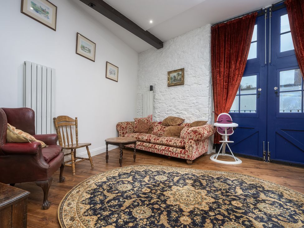 A living room with a sofa and armchair at The Mayflower in Plymouth