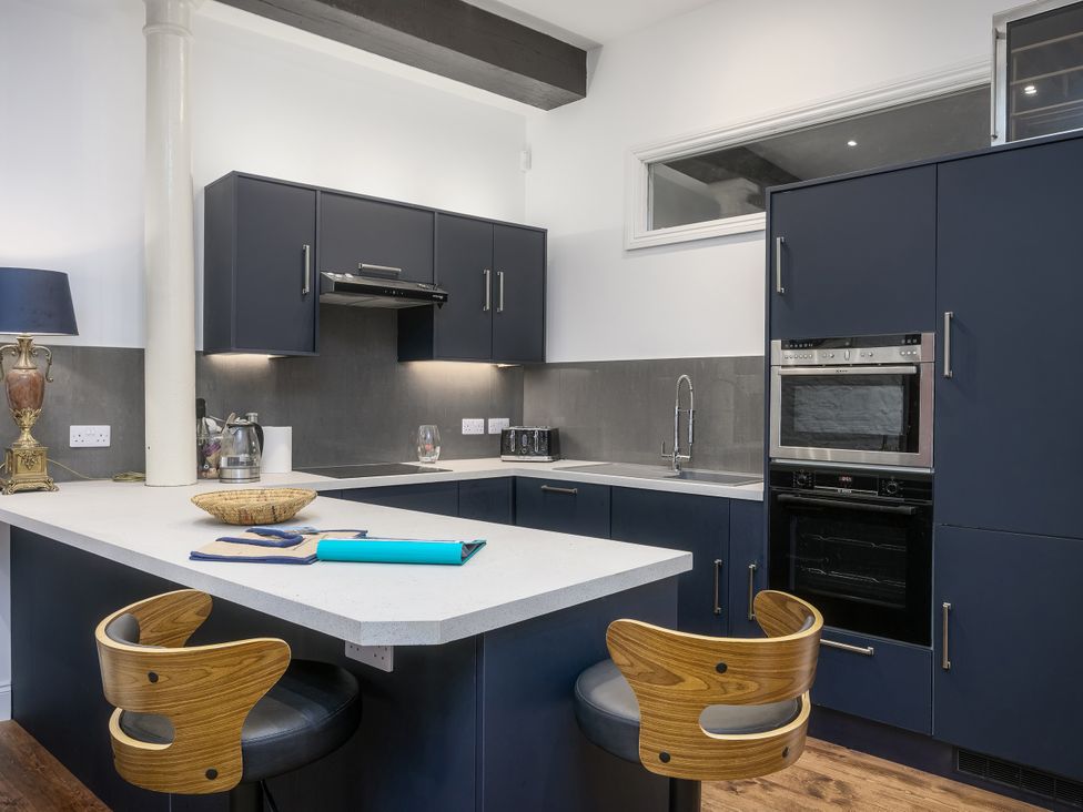A kitchen with cabinets and appliances at The Mayflower in Plymouth