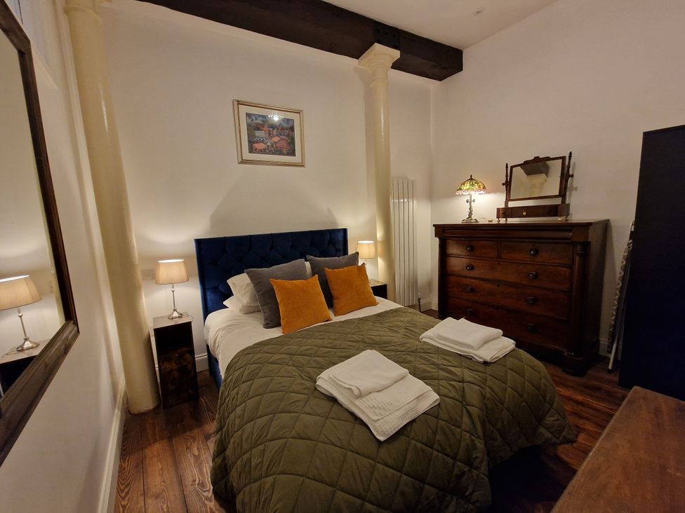 A bedroom with a bed and dresser at The Mayflower in Plymouth