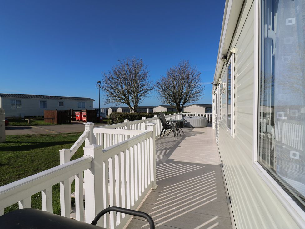 An outdoor area with chairs and a table at Ocean Breeze Escape in Allhallows