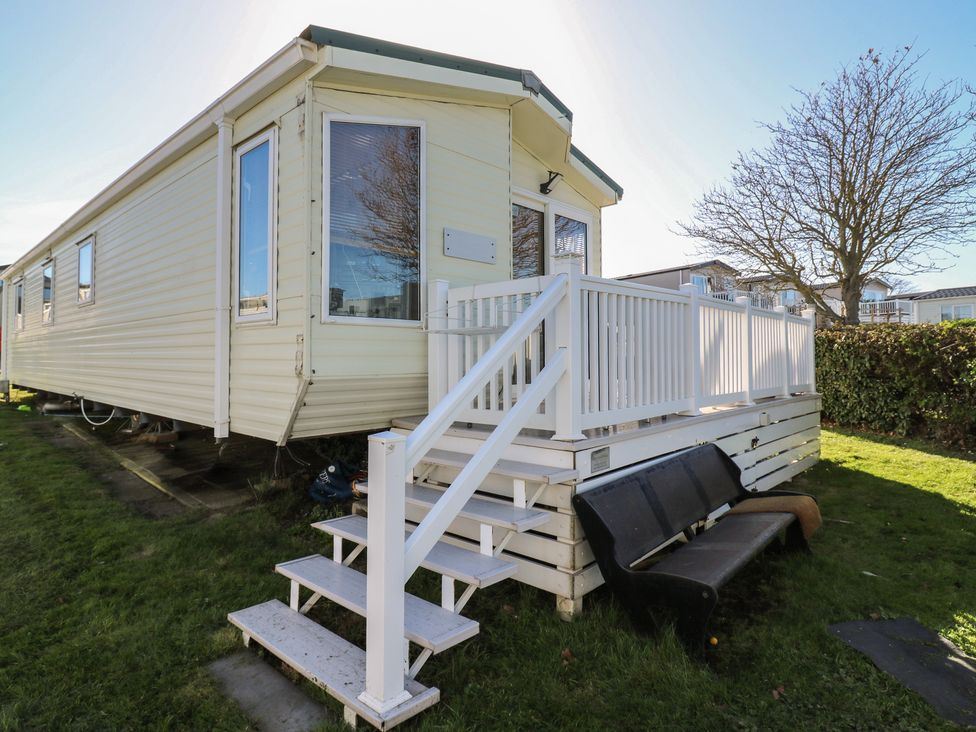 A mobile home with a deck and stairs at Ocean Breeze Escape in Allhallows