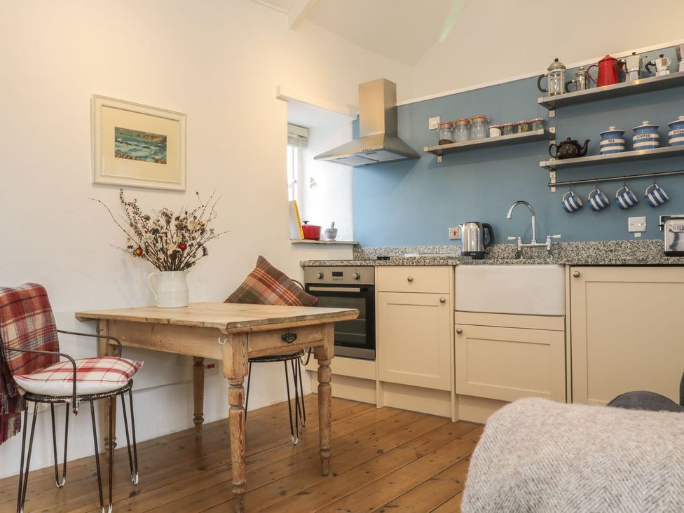 A kitchen with table and chairs at The Old Studio in Penzance