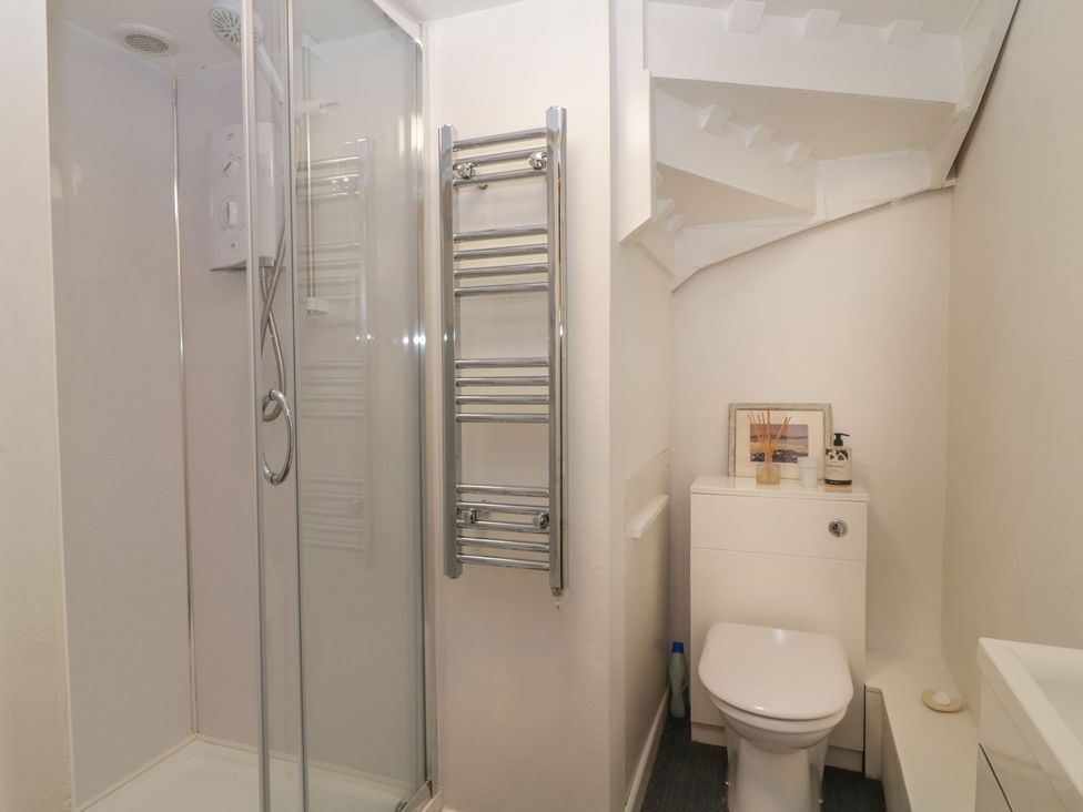 A bathroom with a shower and toilet at The Old Studio in Penzance