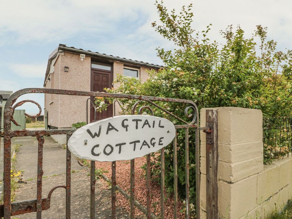 A gate with a sign at Wagtail Cottage