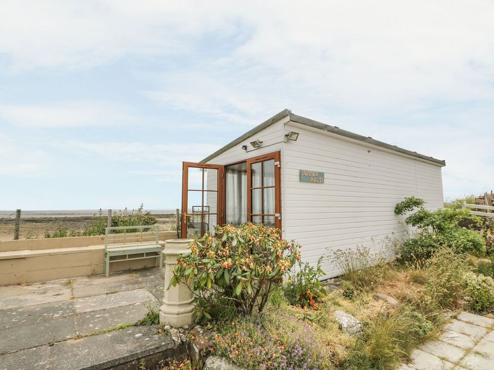 A summer house with a bench and garden at Wagtail Cottage 