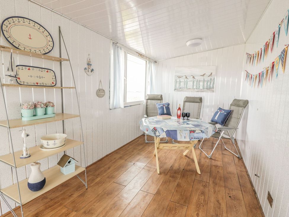 A dining room with a table and chairs at Wagtail Cottage