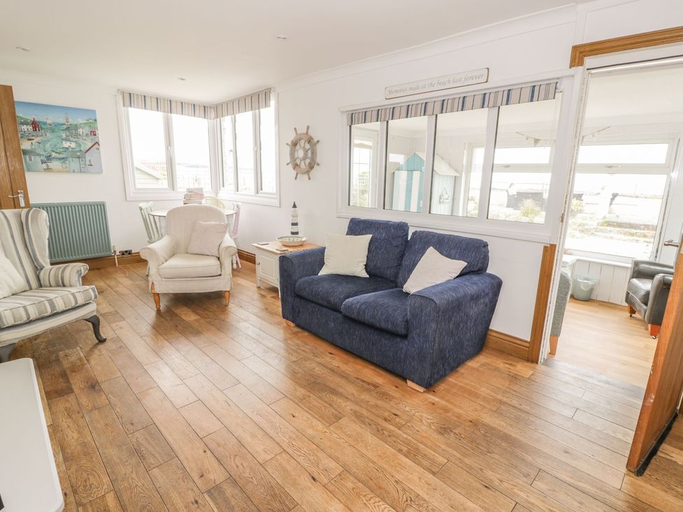 A living room with a sofa and armchairs at Wagtail Cottage