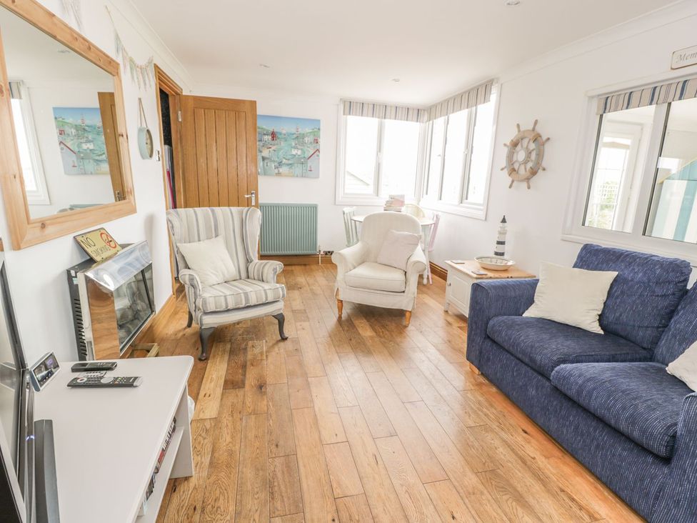 A living room with a sofa and armchair at Wagtail Cottage