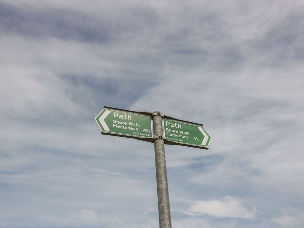 A signpost indicating paths to Mersehead and Carsethorn