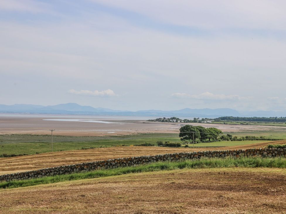 A landscape view of water and fields at Wagtail Cottage