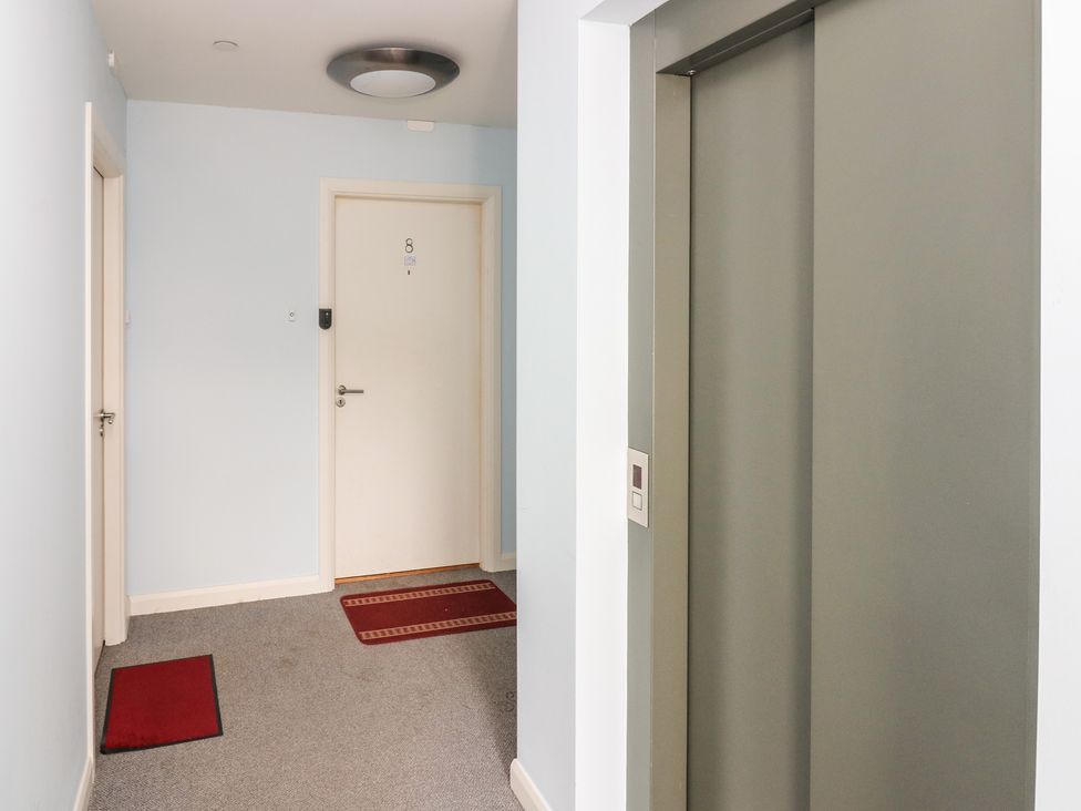 A hallway with an elevator and door at Mill Wharf in Berwick-upon-Tweed