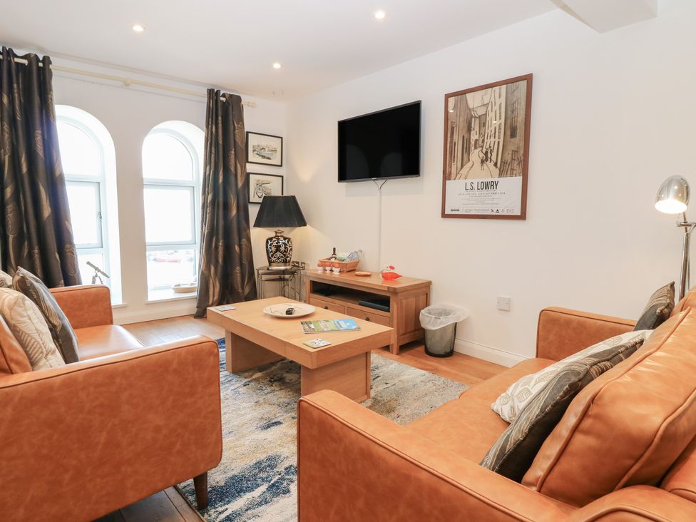 A living room with a sofa and television at Mill Wharf in Berwick-upon-Tweed