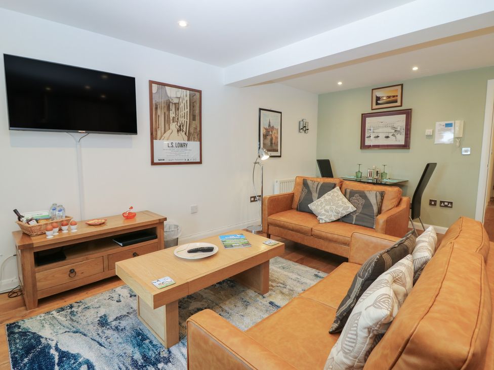 A living room with a television and sofa at Mill Wharf in Berwick-upon-Tweed