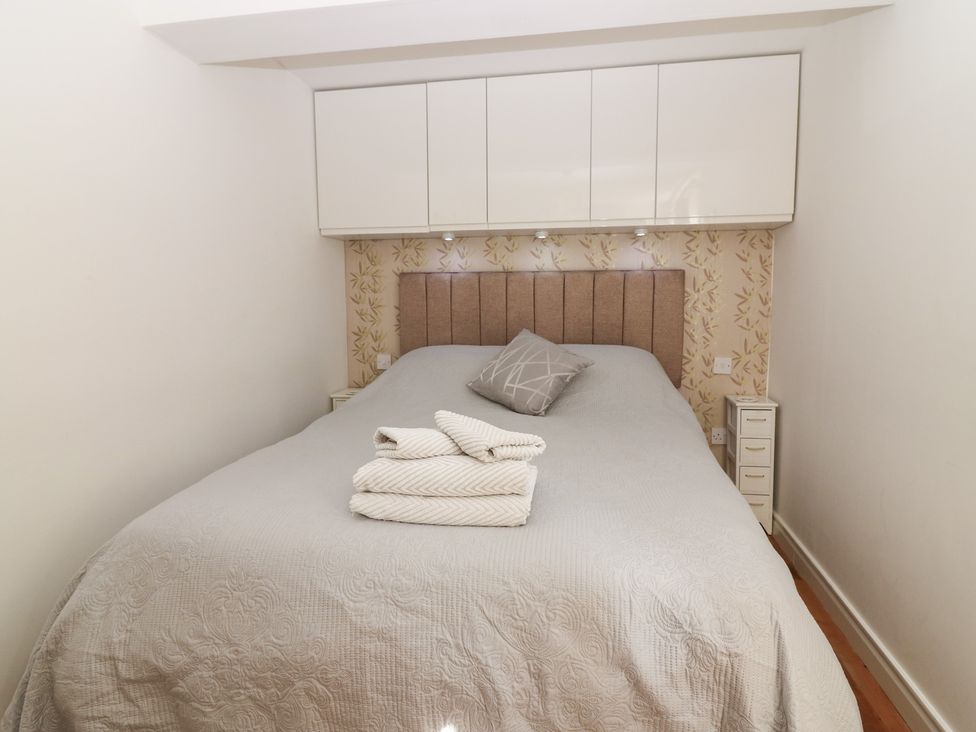 A bedroom with a bed and cabinets at Mill Wharf Berwick-upon-Tweed