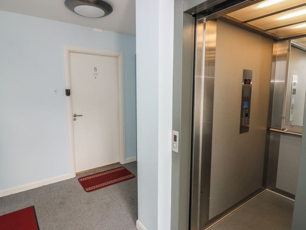 A hallway with an elevator and door at Mill Wharf in Berwick-upon-Tweed