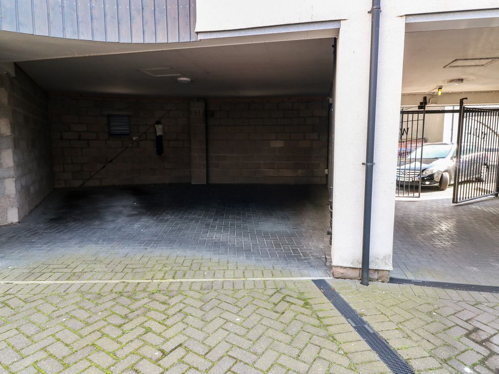 A garage with a parking space and brick walls at Mill Wharf in Berwick-upon-Tweed