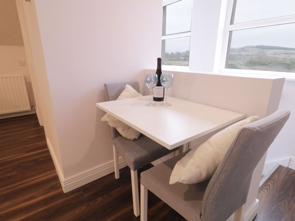 A dining area with a table and two chairs at The Loft - 96B