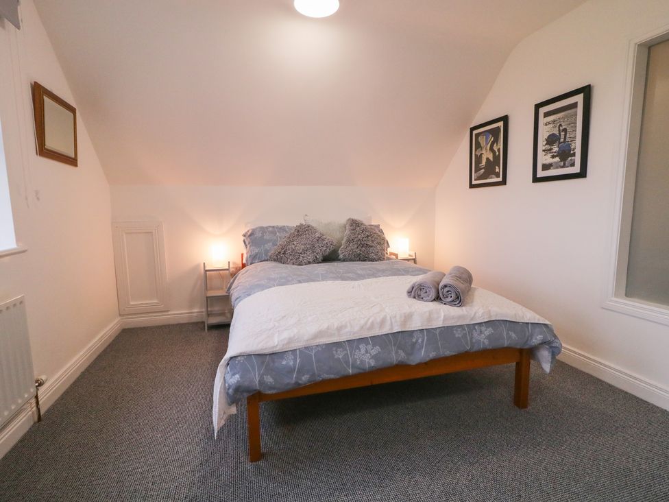 A bedroom with a bed and nightstands at The Loft - 96B