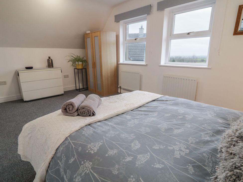 A bedroom with a bed and dresser at The Loft - 96B