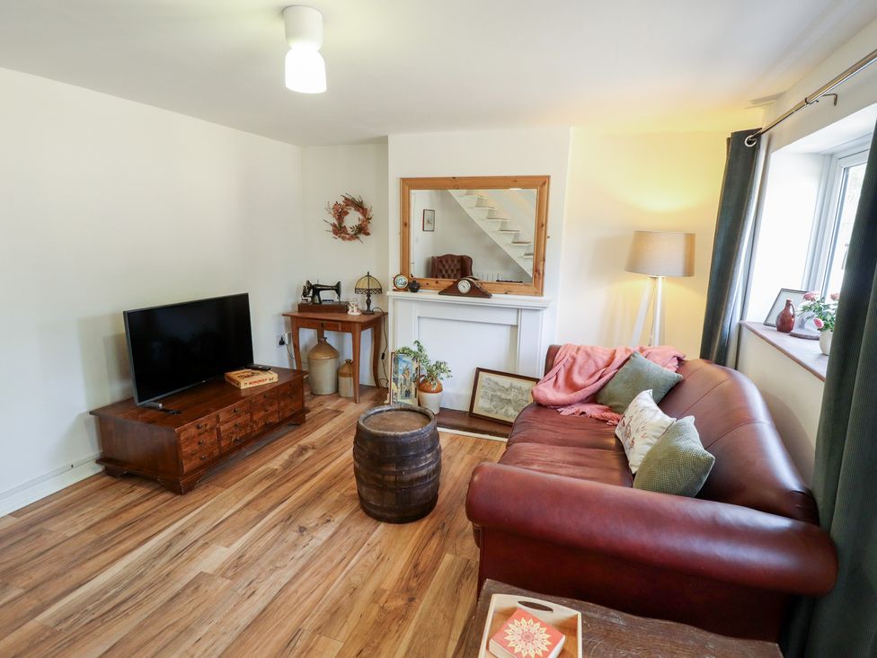 A living room with a television and sofa at 3 Rectory Row