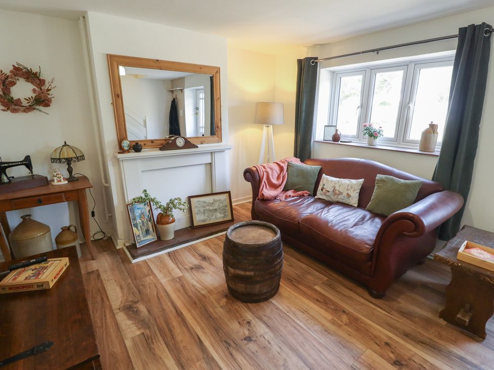 A living room with a sofa and a table at 3 Rectory Row