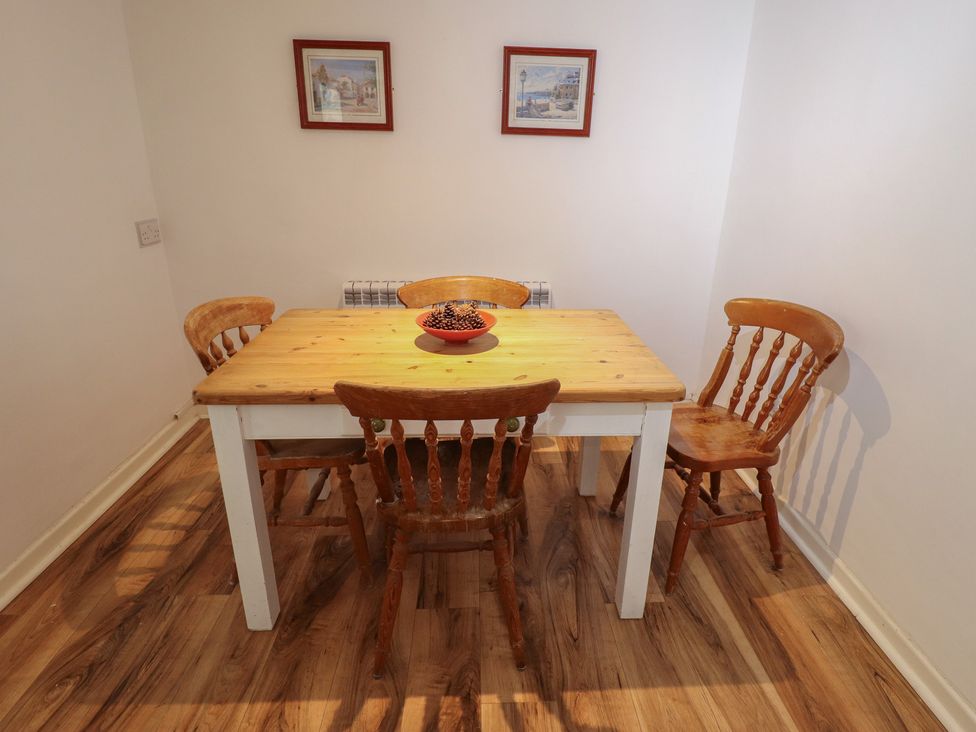 A dining room with a wooden table and chairs at 3 Rectory Row
