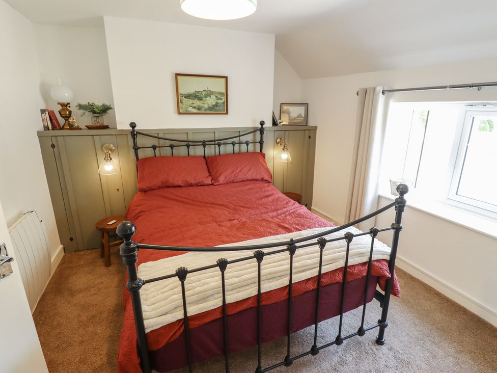 A bedroom with a bed and bedside table at 3 Rectory Row