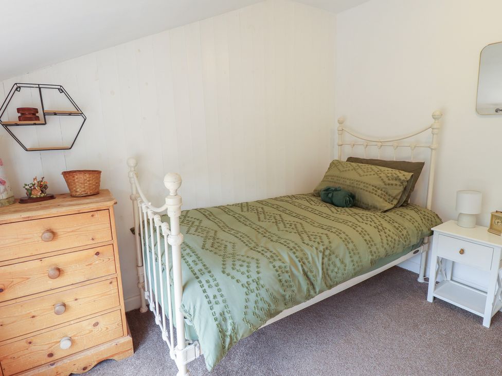 A bedroom with a bed and dresser at 3 Rectory Row 